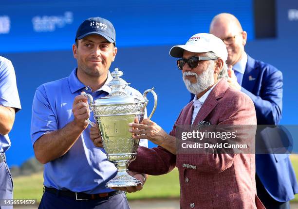 Francesco Molinari of Italy the captain of The Continent of Europe Team is presented with the Hero Cup trophy by Dr Pawan Munjal of India The CEO of...