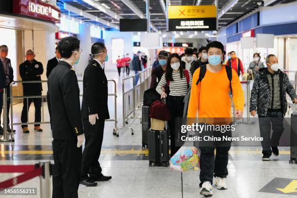 Passengers arrive at Hong Kong West Kowloon Station on January 15, 2023 in Hong Kong, China. Hong Kong and the Chinese mainland resumed their...