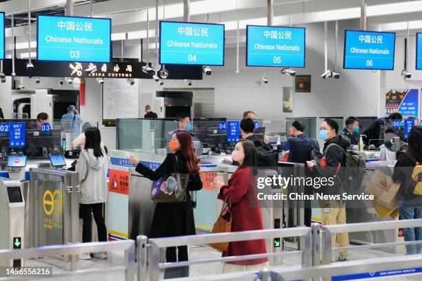 Passengers wait to pass through immigration checkpoints at Hong Kong West Kowloon Station on January 15, 2023 in Hong Kong, China. Hong Kong and the...