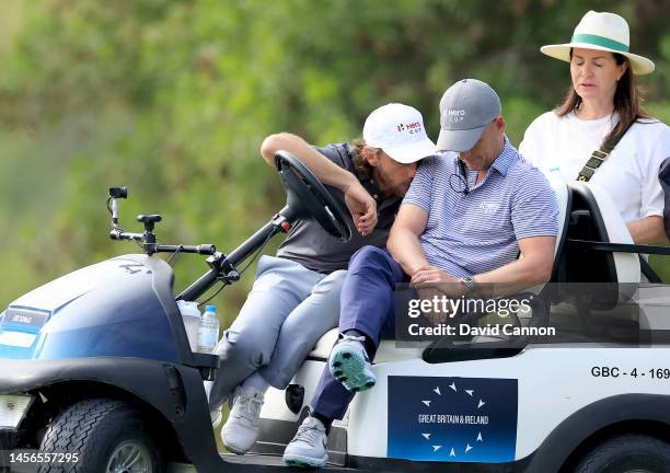 Tommy Fleetwood of England and the Great Britain and Ireland Team watches the golf in despair on the 17th hole with Luke Donald of England during the...