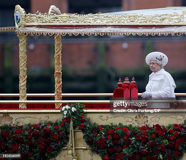 Queen Elizabeth sails on the royal barge 'The Spirit of Chartwell' during the Thames Diamond Jubilee River Pageant during the Thames Diamond Jubilee...