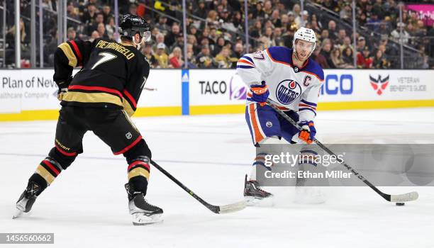 Connor McDavid of the Edmonton Oilers skates with the puck against Alex Pietrangelo of the Vegas Golden Knights in the first period of their game at...