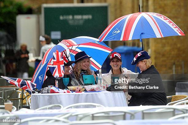Party-goers shelter from the rain at the Kings road street party on June 3, 2012 in London, England. For only the second time in its history the UK...