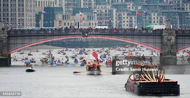 The flotilla makes its way along as part of The Thames River Pageant, part of the Diamond Jubilee, marking the 60th anniversary of the accession of...