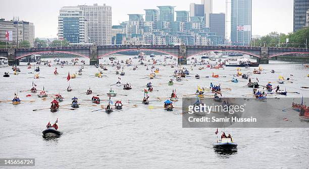 The flotilla makes its way along as part of The Thames River Pageant, part of the Diamond Jubilee, marking the 60th anniversary of the accession of...