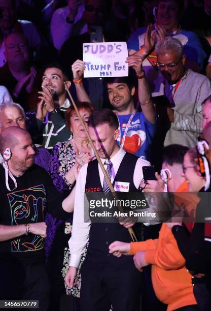 Man holds a sign reading 'Judd's the only Trump for me!' as Judd Trump of England enter the arena prior to the Cazoo Masters Final against Mark...