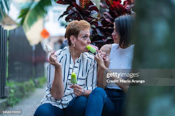 mama und tochter essen ihr eis - girl eating messy ice cream cone stock-fotos und bilder