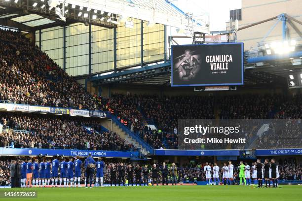 Players, officials and fans hold a minutes applause in memory of former Chelsea player Gianluca Vialli as an LED screen displays an image of...