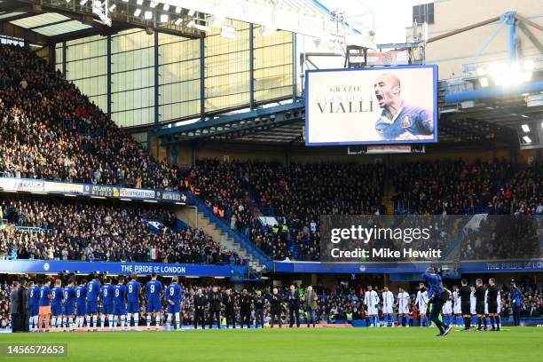 Players, officials and fans hold a minutes applause in memory of former Chelsea player Gianluca Vialli as an LED screen displays an image of...