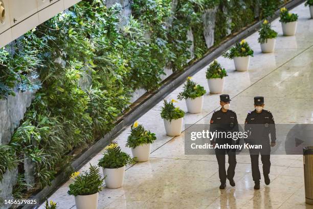 People's armed police patrol at the departure hall at the West Kowloon Station on January 15, 2023 in Hong Kong, China. Hong Kong reopened high speed...