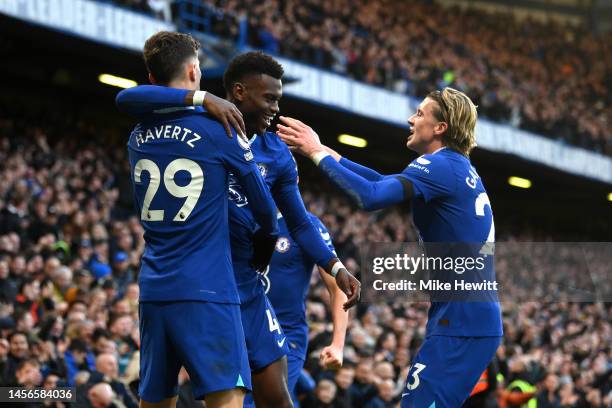 Kai Havertz of Chelsea celebrates with teammate Benoit Badiashile and Conor Gallagher after scoring the team's first goal during the Premier League...