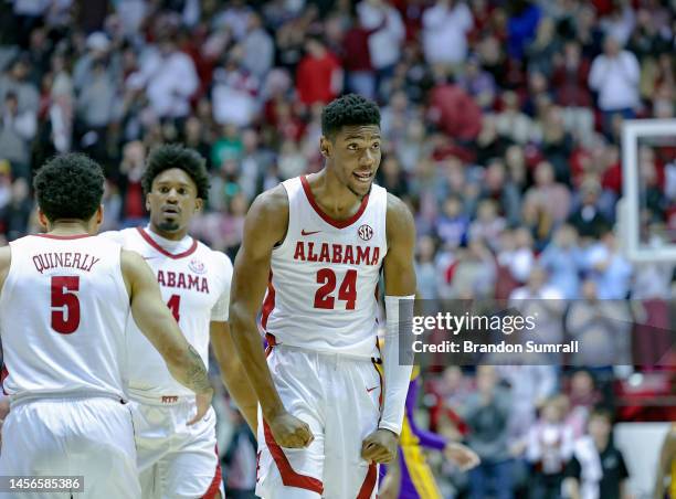 Brandon Miller of the Alabama Crimson Tide reacts after knocking down a first period three point basket during a timeout against the LSU Tigers at...