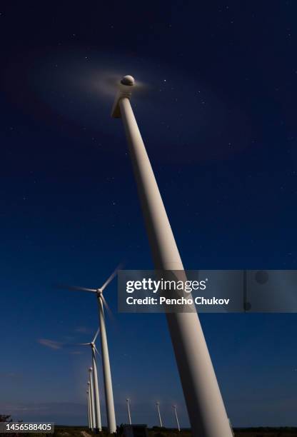 wind turbines on field against sky at night - varna bulgaria stock pictures, royalty-free photos & images