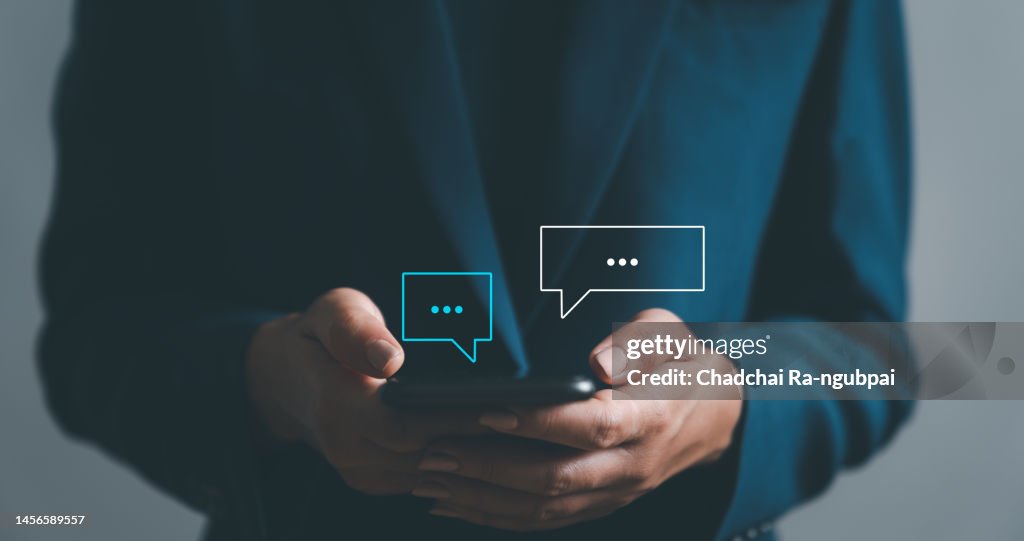 Women hand using smartphone typing Live chat chatting and social network concepts, chatting conversation working at home in chat box icons pop up. Social media marketing technology concept.