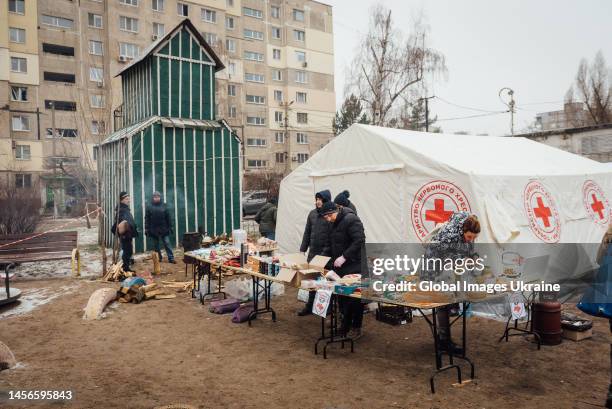 Red Cross and UNHCR representatives distribute food, heating and humanitarian aid to the victims on January 15, 2023 in Dnipro, Ukraine. Part of the...