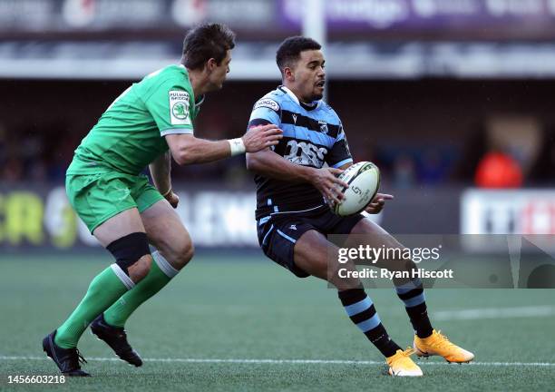 Ben Thomas of Cardiff Rugby offloads the ball whilst under pressure during the European Challenge Cup Pool A match between Cardiff Rugby and...