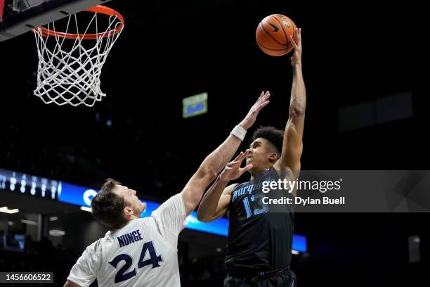 Oso Ighodaro of the Marquette Golden Eagles attempts a shot while being guarded by Jack Nunge of the Xavier Musketeers in the first half at the...