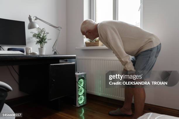 senior man with gamer pc at home - home business garage stock pictures, royalty-free photos & images