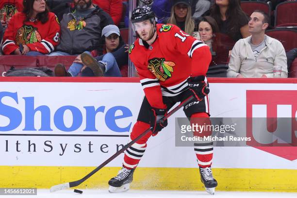 Taylor Raddysh of the Chicago Blackhawks skates with the puck against the Seattle Kraken during the third period at United Center on January 14, 2023...