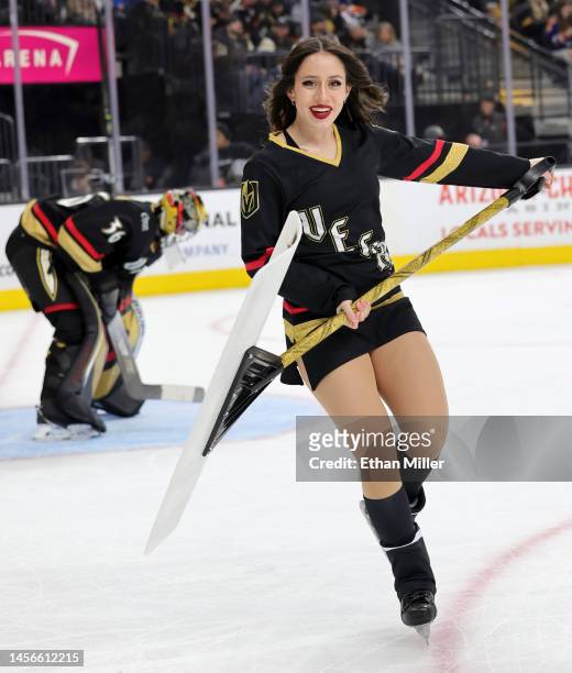 Member of the Knights Guard cleans the ice as Logan Thompson of the Vegas Golden Knights waits in the crease in the third period of a game against...