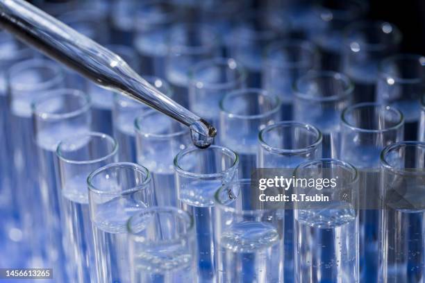 laboratory glassware with pipette dropping fluid into test tube - vial stock pictures, royalty-free photos & images