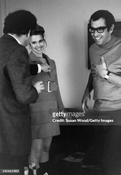 American author & screenwriter Terry Southern clowns around with actress Jane Fonda and her husband, French film director Roger Vadim left), during a...