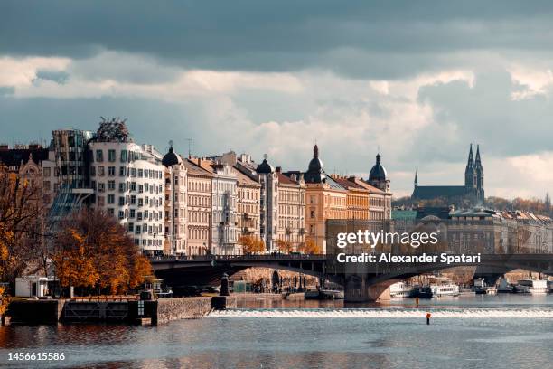 prague skyline with dancing house, vysehrad basilica and vltava river, czech republic - vltava river stockfoto's en -beelden