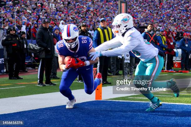 Dawson Knox of the Buffalo Bills catches a pass for a touchdown against the Miami Dolphins during the first quarter of the game in the AFC Wild Card...