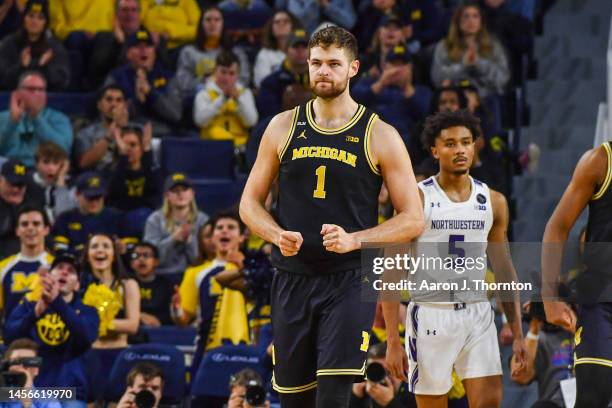 Hunter Dickinson of the Michigan Wolverines reacts after making a basket during the second half of a college basketball game against the Northwestern...