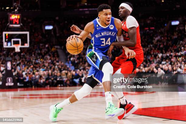 Giannis Antetokounmpo of the Milwaukee Bucks drives against Chris Boucher of the Toronto Raptors during the second half of their NBA game at...