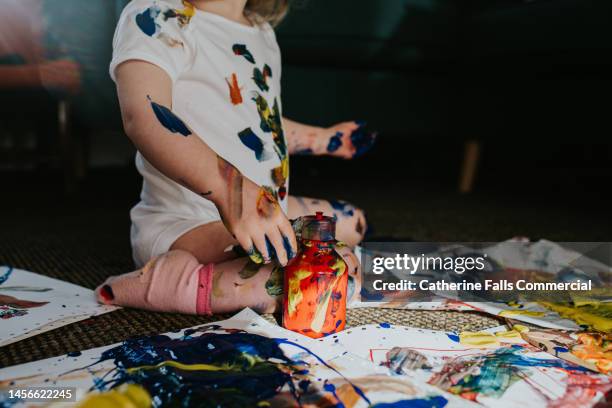 twin girls create a huge mess with primary coloured paints - kids mess stock pictures, royalty-free photos & images