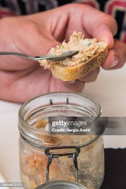 spreading potted senegalese seafood starter - pate stock pictures, royalty-free photos & images