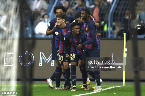 Robert Lewandowski of FC Barcelona celebrates with teammates after scoring the side's second goal during the Super Copa de Espana Final match between...