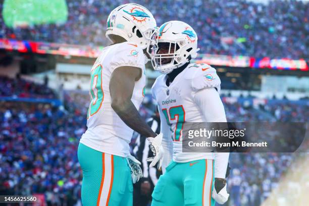 Tyreek Hill of the Miami Dolphins celebrates his successful two point conversion with teammate Jaylen Waddle during the second quarter against the...