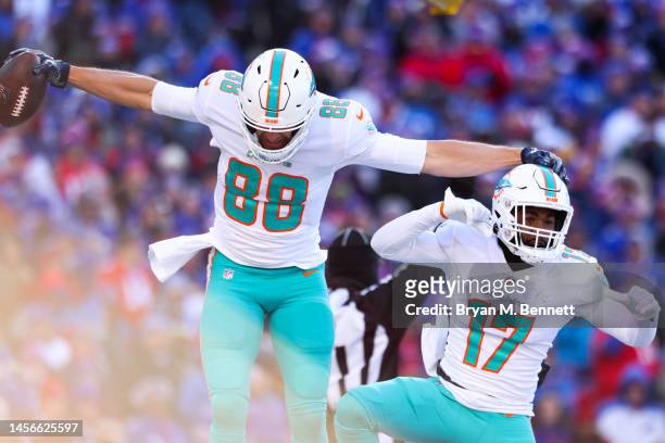 Mike Gesicki of the Miami Dolphins celebrates after scoring a touchdown with teammate Jaylen Waddle during the second quarter against the Buffalo...
