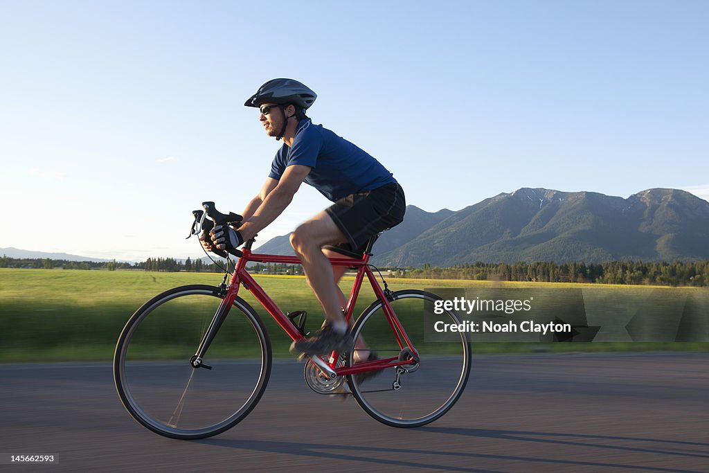 Man riding road bike in mountains