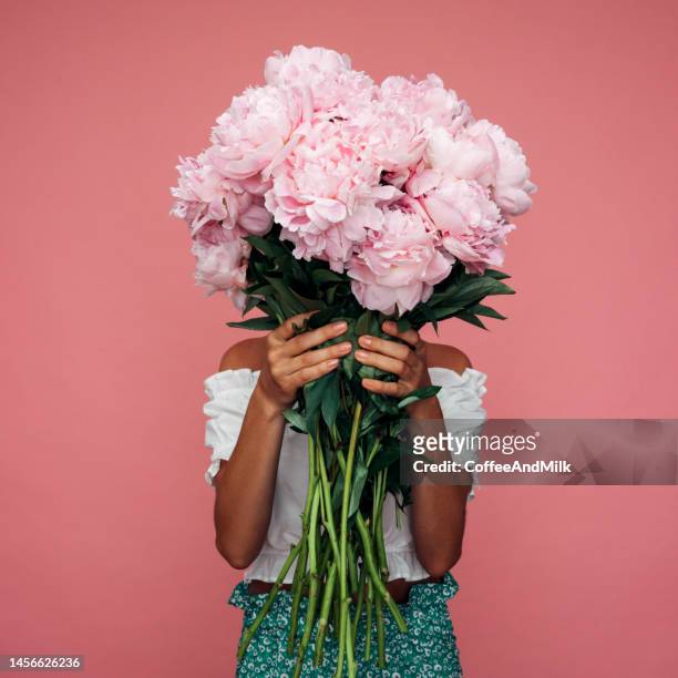 beautiful emotional woman holding bouquet of flowers - bouquet of flowers stock pictures, royalty-free photos & images