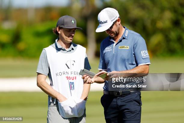 Lanto Griffin of the United States talks with his caddie on the 18th fairway during the first round of The Bahamas Great Exuma Classic at Sandals...