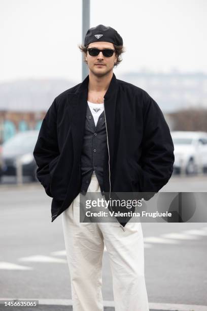 Guido Milani is seen wearing a suede bomber jacket, Prada t-shirt, cardigan and Prada berret outside the Prada show during the Milan Menswear...