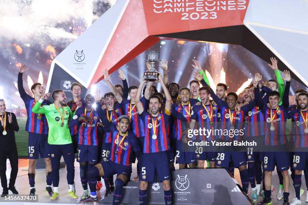 Sergio Busquets of FC Barcelona lifts the Super Copa de Espana trophy after the team's victory during the Super Copa de Espana Final match between...