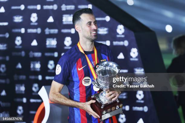 Sergio Busquets of FC Barcelona lifts the Super Copa de Espana trophy after the team's victory during the Super Copa de Espana Final match between...