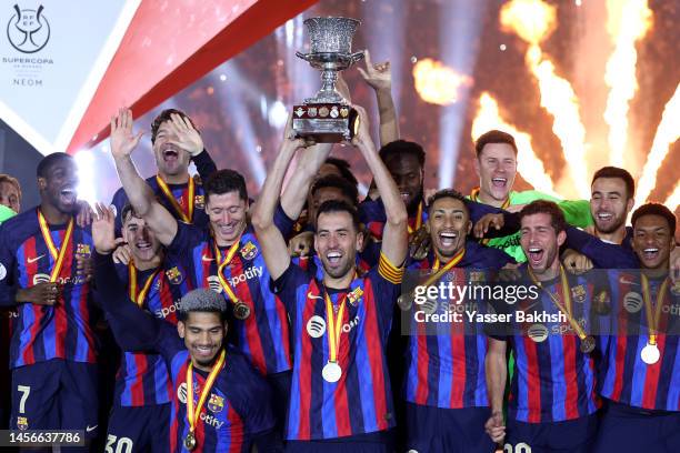 Sergio Busquets of FC Barcelona lifts the Super Copa de Espana trophy after the team's victory during the Super Copa de Espana Final match between...