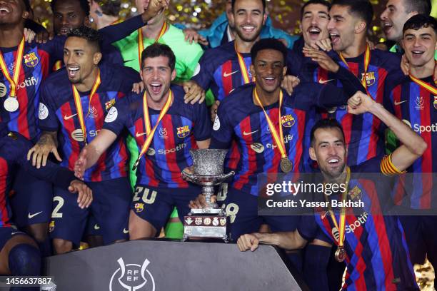 Barcelona players celebrate with the Super Copa de Espana trophy after the team's victory during the Super Copa de Espana Final match between Real...