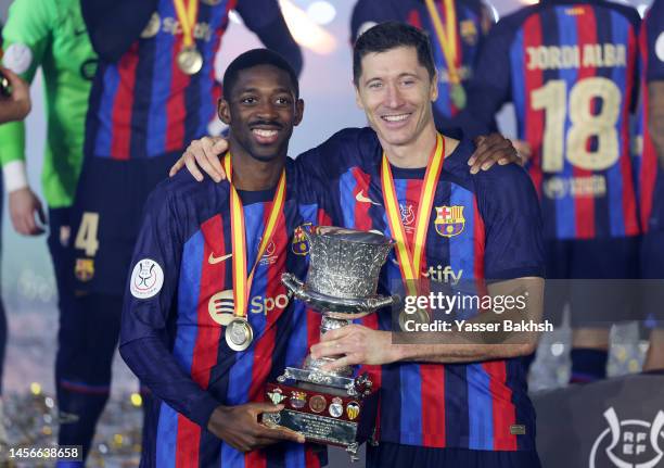 Ousmane Dembele and Robert Lewandowski of FC Barcelona celebrate with the Super Copa de Espana trophy after the team's victory during the Super Copa...