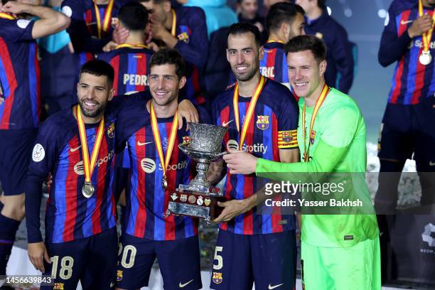 Jordi Alba, Sergi Roberto, Sergio Busquets and Marc-Andre ter Stegen of FC Barcelona pose for a photo with the Super Copa de Espana trophy after the...