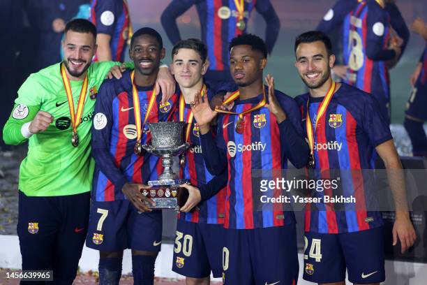 Ousmane Dembele, Gavi, Ansu Fati and Eric Garcia of FC Barcelona celebrate with the Super Copa de Espana trophy after the team's victory during the...