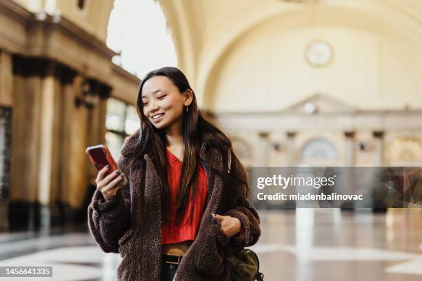 asian woman at train station - europe asian culture stockfoto's en -beelden