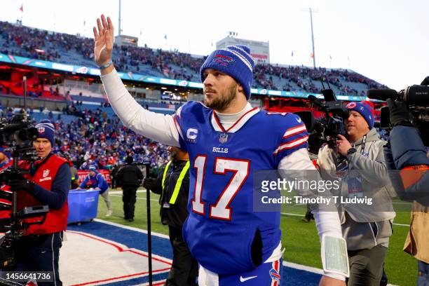 Josh Allen of the Buffalo Bills walks off the field after defeating the Miami Dolphins 34-31 in the AFC Wild Card playoff game at Highmark Stadium on...