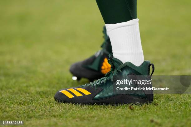 Detail view of the football cleats worn by Aaron Rodgers of the Green Bay Packers before a game against the Detroit Lions at Lambeau Field on January...