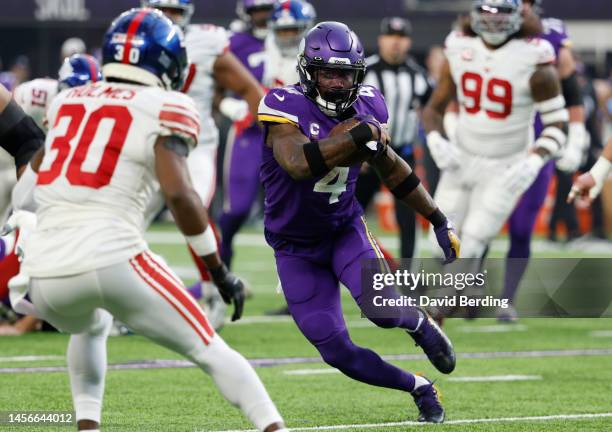 Dalvin Cook of the Minnesota Vikings rushes during the first quarter against the New York Giants in the NFC Wild Card playoff game at U.S. Bank...